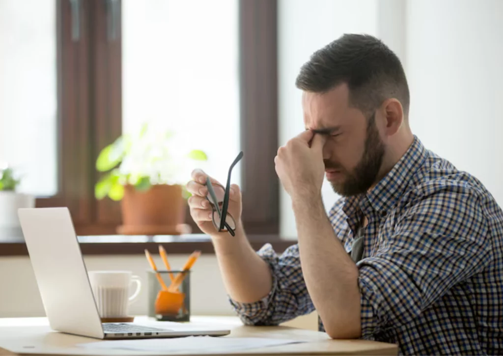 stressed-male-massaging-nose-bridge-suffering-from-headache_1163-3988