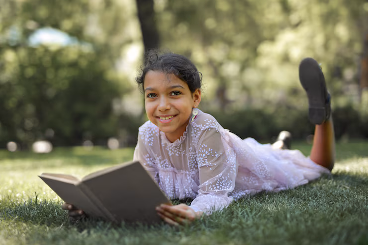 little girl reading a book in natureland jamshedpur